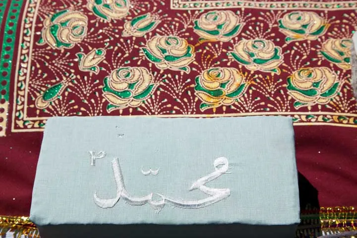 Embroidered weight at head